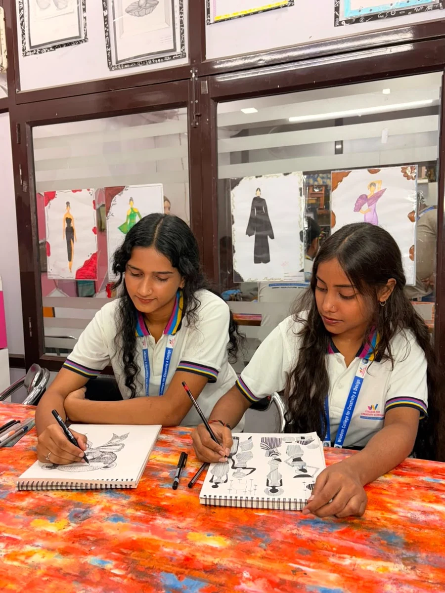 Wisdom College students sketching fashion illustrations